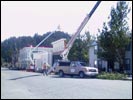 Workers placing tree to help hide 'modern' motel; behind is the north (rear) side of Town Hall...in the lower sections you can see the dark gray US Bank building tucked inside the facade